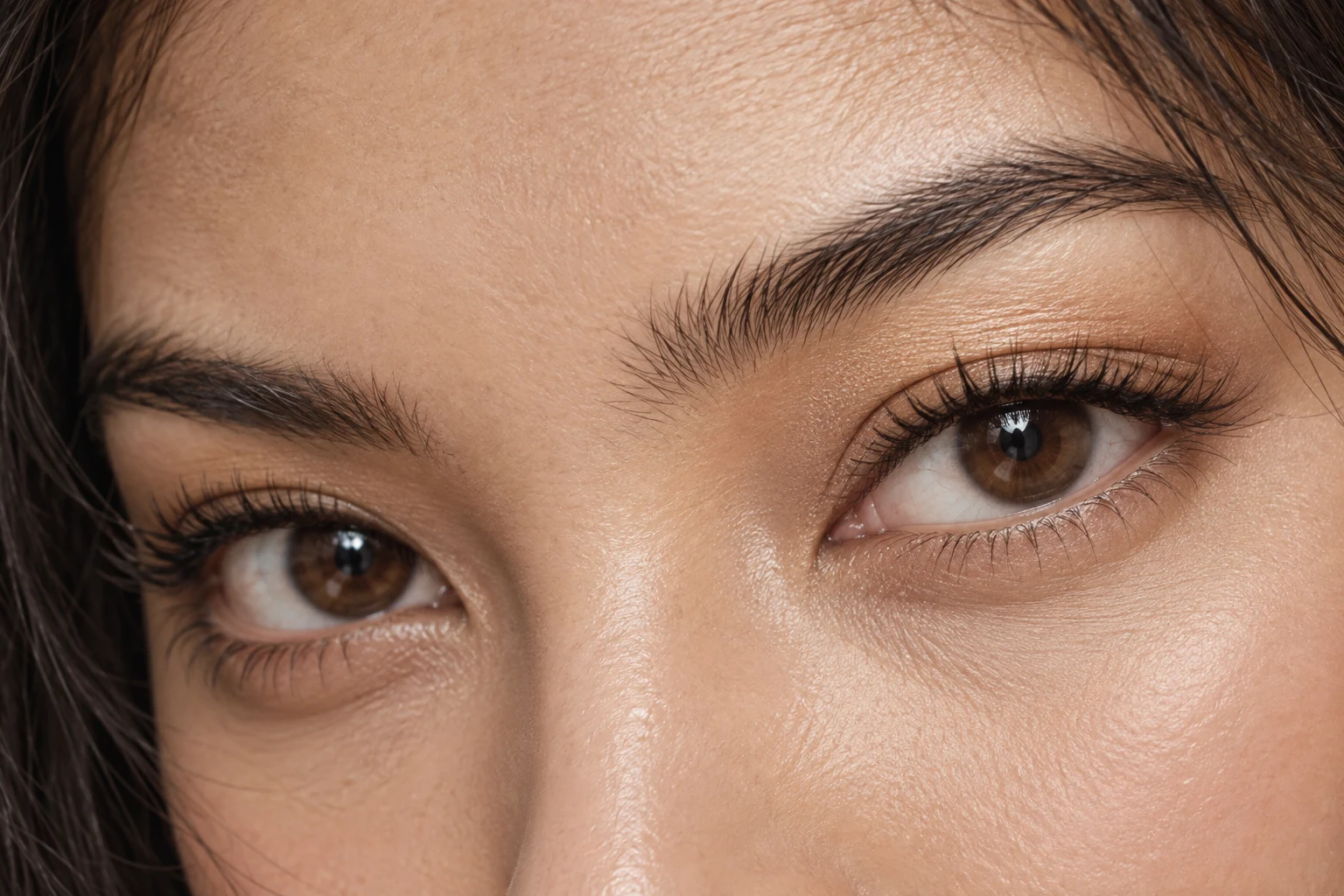 Close-up of brown eyes with softly curled eyelashes